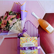 Load image into Gallery viewer, Celebrate in style with a lush bouquet of pink roses and purple lisianthus, paired with a sparkling bellini and a sleek box of Godiva chocolates. Wrapped in rich purple and gold with a 'Congrats to you' tag. Same-day flower delivery in Las Vegas and Henderson available