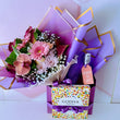 Load image into Gallery viewer, Celebrate in style with a lush bouquet of pink roses and purple lisianthus, paired with a sparkling bellini and a sleek box of Godiva chocolates. Wrapped in rich purple and gold with a 'Congrats to you' tag. Same-day flower delivery in Las Vegas and Henderson available