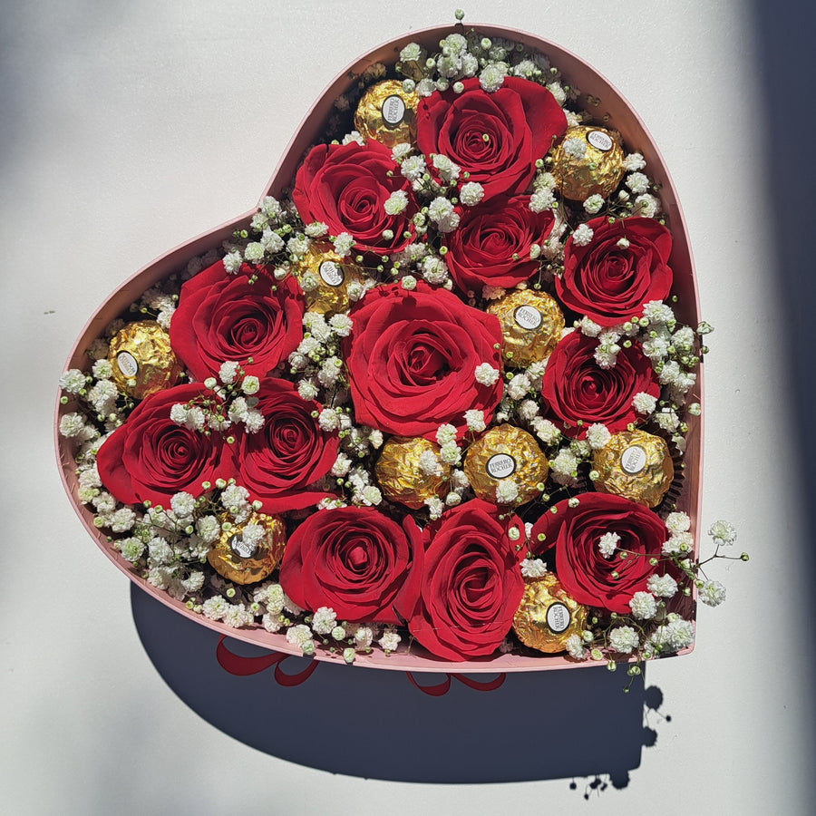 Red roses speak the language of deep love and passion, while Ferrero Rocher chocolates add a touch of golden indulgence. Together, they create a timeless gift of romance and elegance.

Perfect for anniversaries, birthdays, or just because—this beautifully arranged box of fresh red roses and decadent chocolates will melt hearts and create unforgettable moments.

Hand-delivered the same day in Las Vegas. Shop local and send love with a gift that says it all.