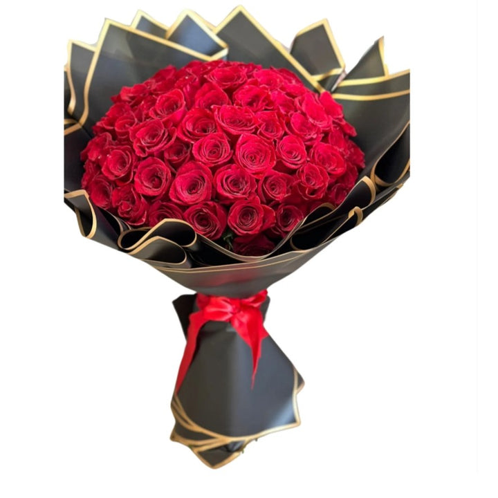 Bouquet of red roses wrapped in black paper with a red ribbon on a white background. Luxurious red rose floral arrangement in Las Vegas, Henderson, and Summerlin.