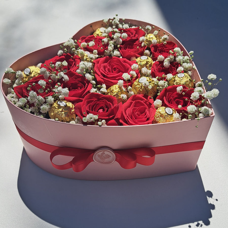 Red roses speak the language of deep love and passion, while Ferrero Rocher chocolates add a touch of golden indulgence. Together, they create a timeless gift of romance and elegance.

Perfect for anniversaries, birthdays, or just because—this beautifully arranged box of fresh red roses and decadent chocolates will melt hearts and create unforgettable moments.

Hand-delivered the same day in Las Vegas. Shop local and send love with a gift that says it all.